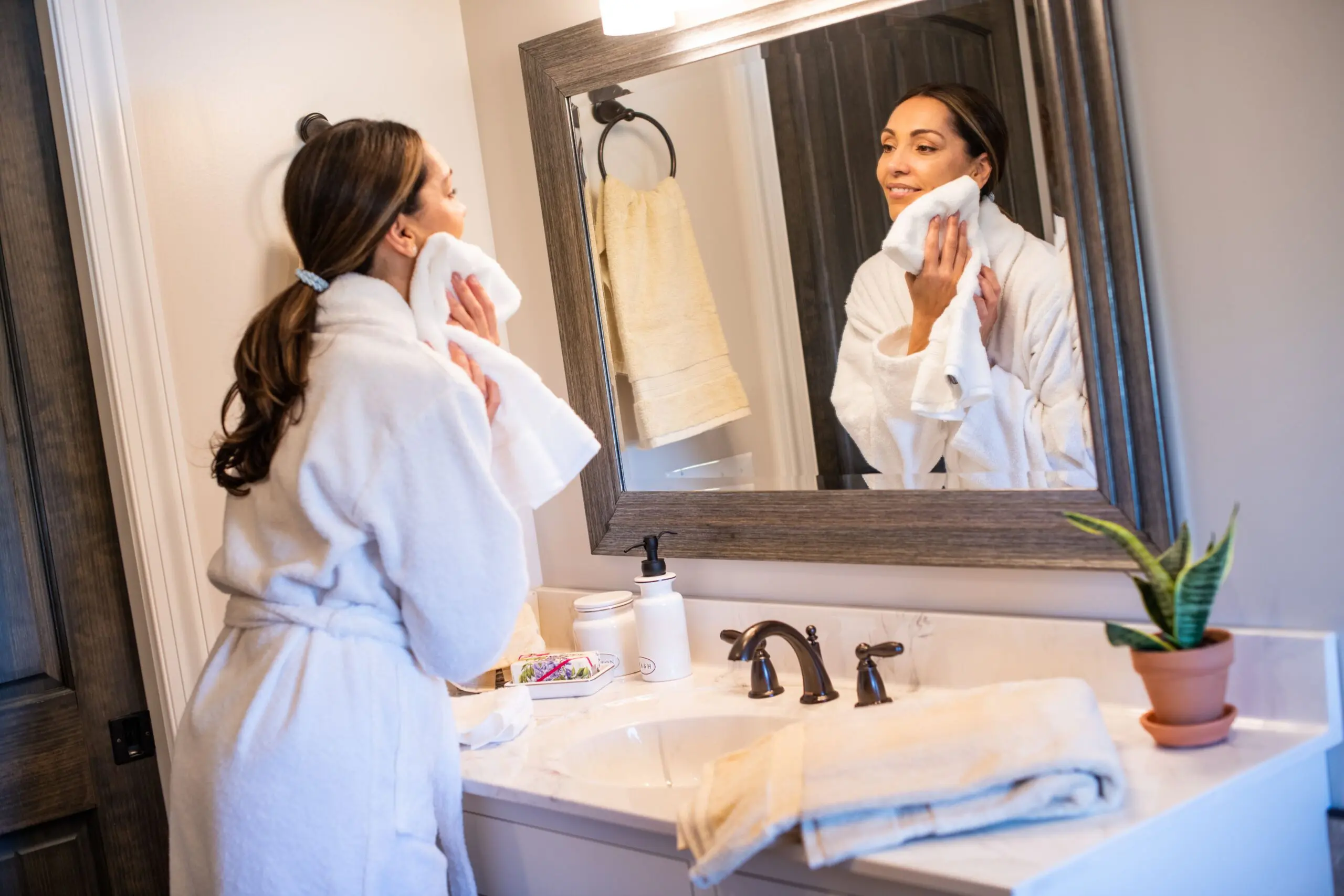 Woman drying her face with American Blossom linens